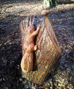 Stump memorial with squirrel and wren.