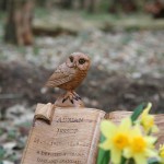Carved book memorial with little owl.